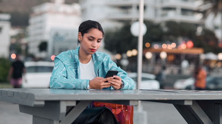 woman texting outdoors