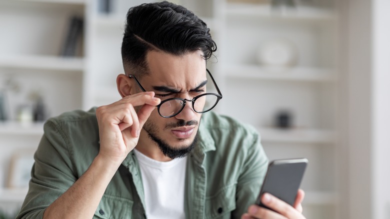 person frowning at phone