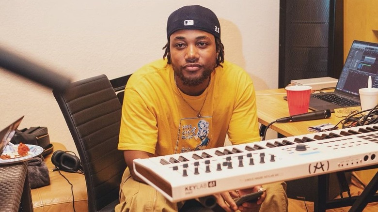 Leon Thomas III sitting in front of keyboard