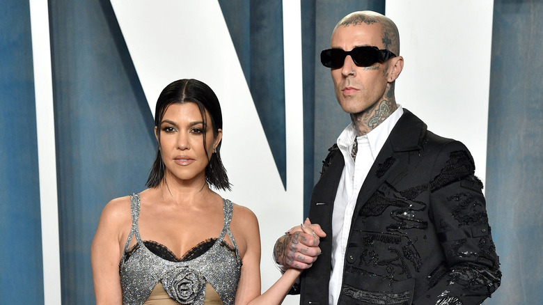 Kourtney Kardashian and Travis Barker pose on the red carpet together