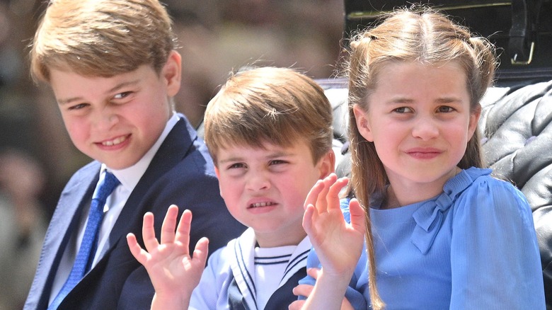 Prince George with his siblings waving