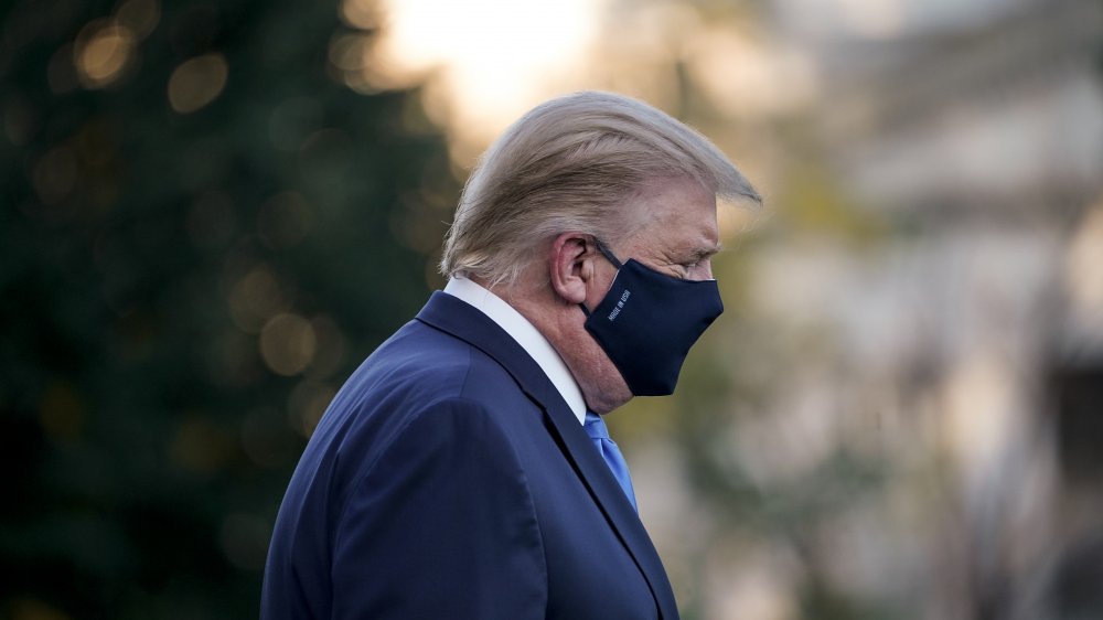 Trump with a mask heading to a chopper