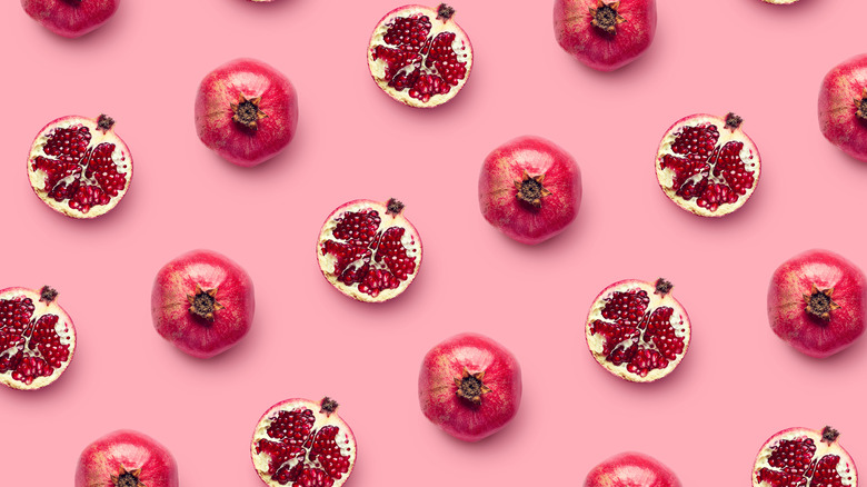 A pattern of pomegranates on a pink background