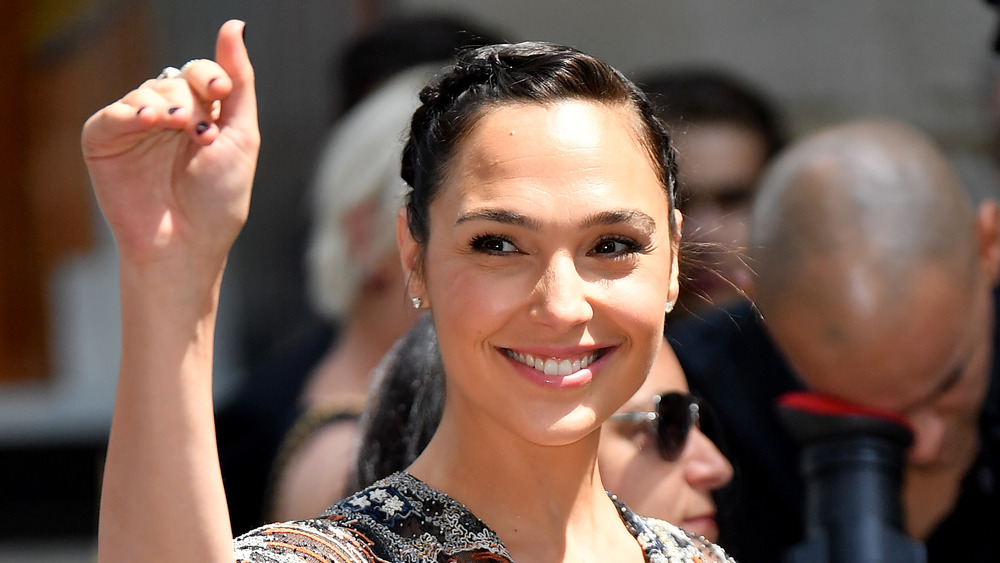 Gal Gadot smiling and waving