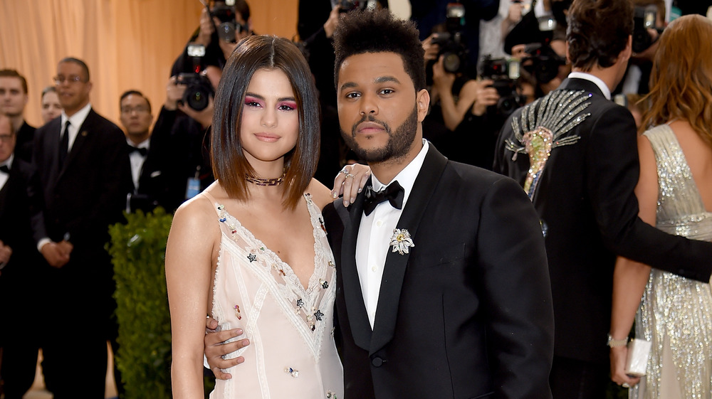 Selena Gomez and The Weeknd posing