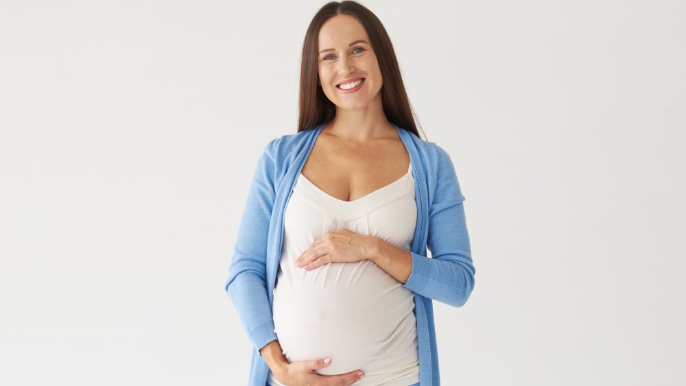 standing pregnant woman