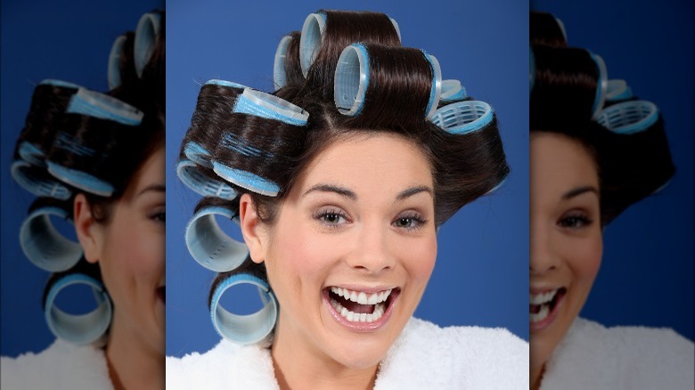 woman smiling with rollers in 