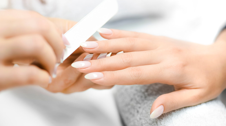 Woman getting her nails filed