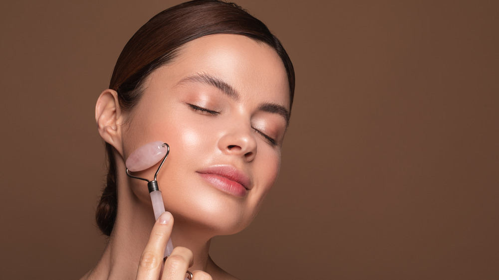 Woman using face roller