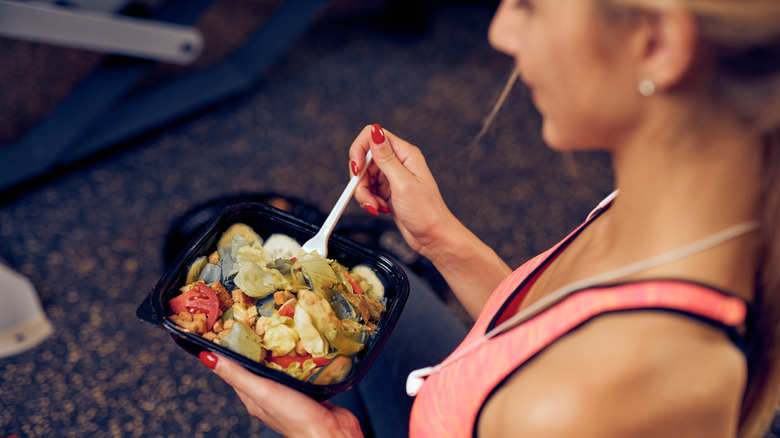 Fit woman eating healthy meal