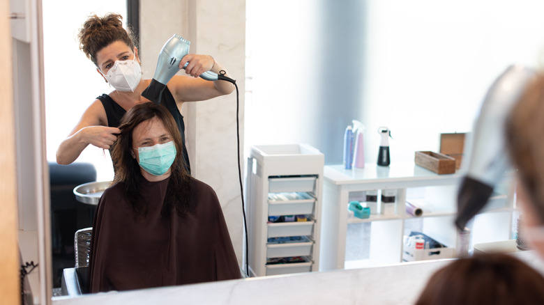 Woman at salon getting haircut