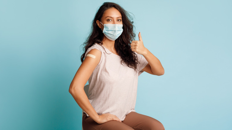 Vaccinated woman giving thumbs up