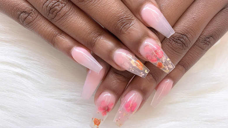 Woman with floral design pink coffin nails