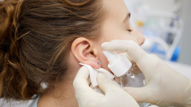 Girl getting ear piercing