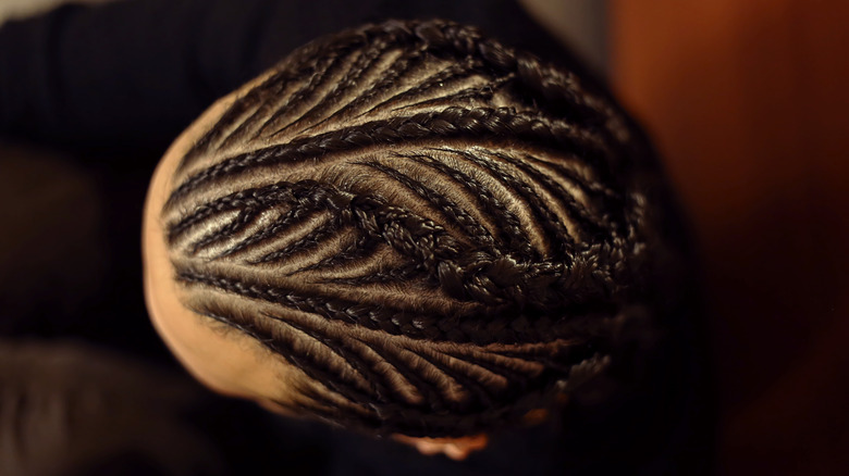 Black woman with micro cornrows