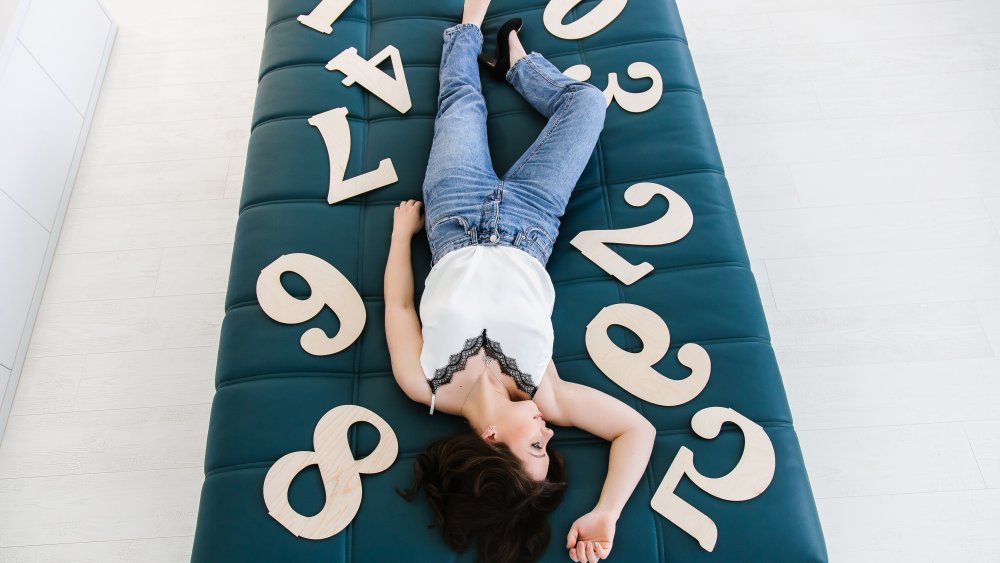 person surrounded by enneagram numbers