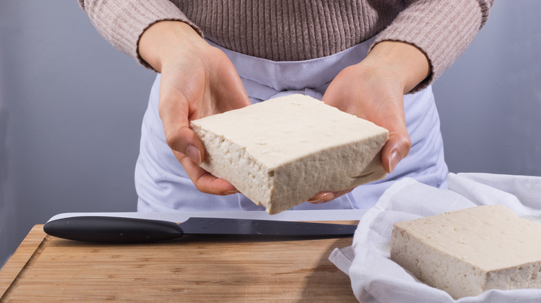 woman holding tofu block