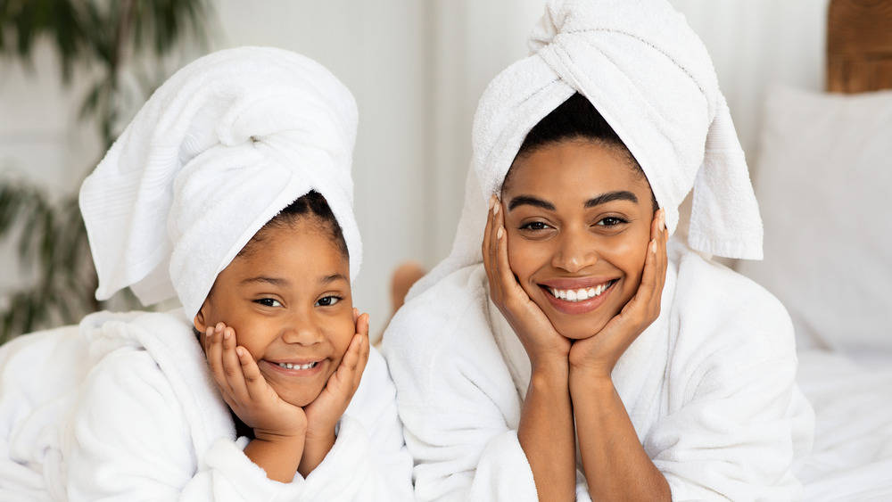 Mother and daughter wearing bathrobes