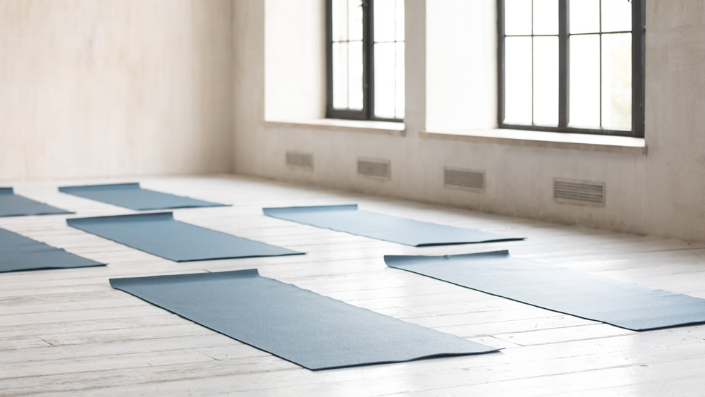 Unrolled yoga mats on floor