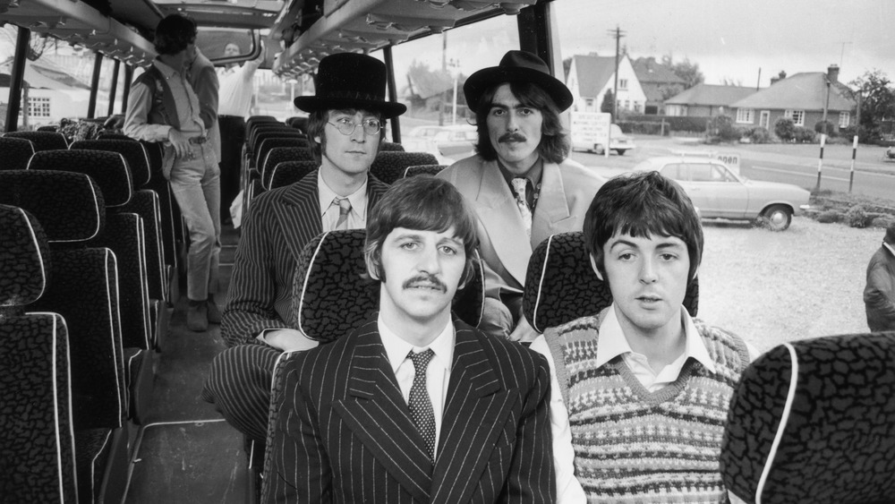 The Beatles sitting in a bus