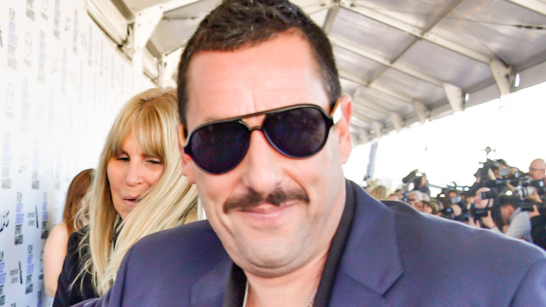 Adam Sandler wearing sunglasses and mustache