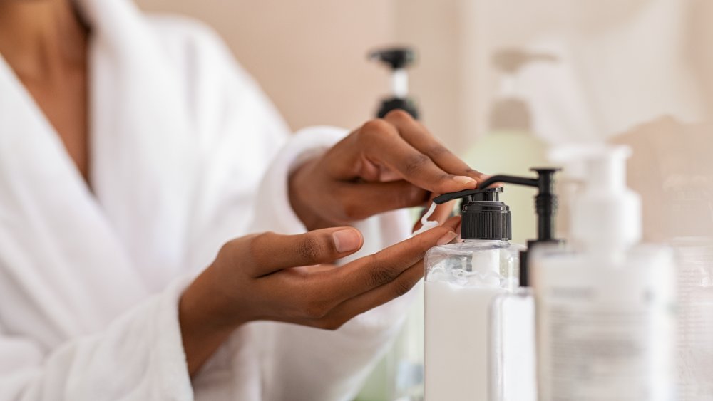 Woman pressing lotion pump