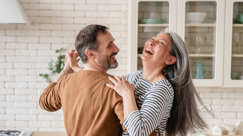 happy couple dancing in kitchen