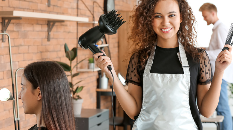 Hair stylist working with client