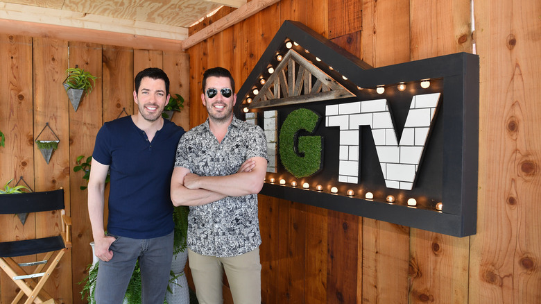 Property Brothers standing in front of HGTV sign