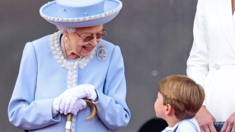 Queen Elizabeth looking at Prince Louis 