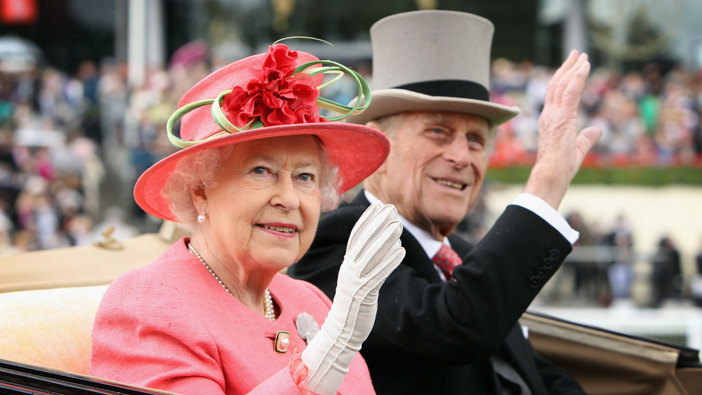 Queen Elizabeth and Prince Philip waving