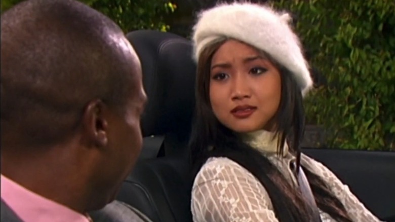 Brenda Song in The Suite Life of Zack and Cody, wearing a fuzzy white beret in a car