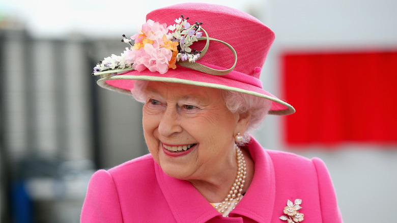 Queen Elizabeth wearing a pink suit