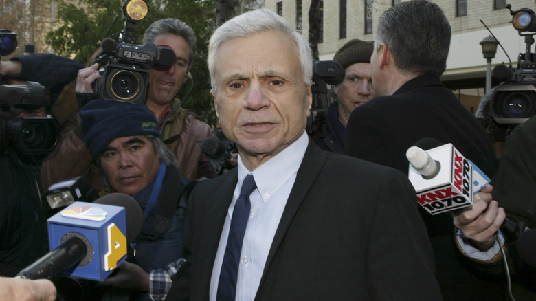 Robert Blake looking stern outside a courthouse