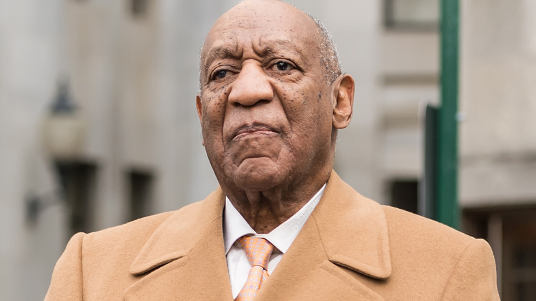 Bill Cosby looks up, scowling