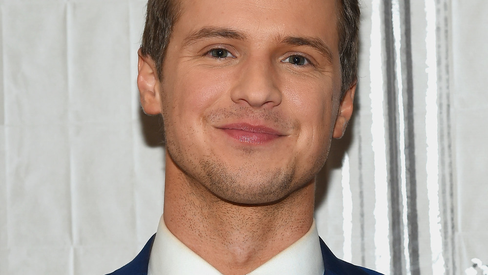 Freddie Stroma smiling with stubble