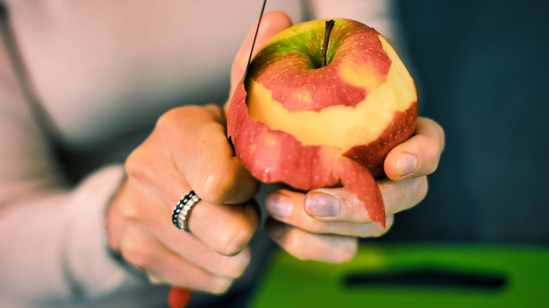 Woman cutting an apple