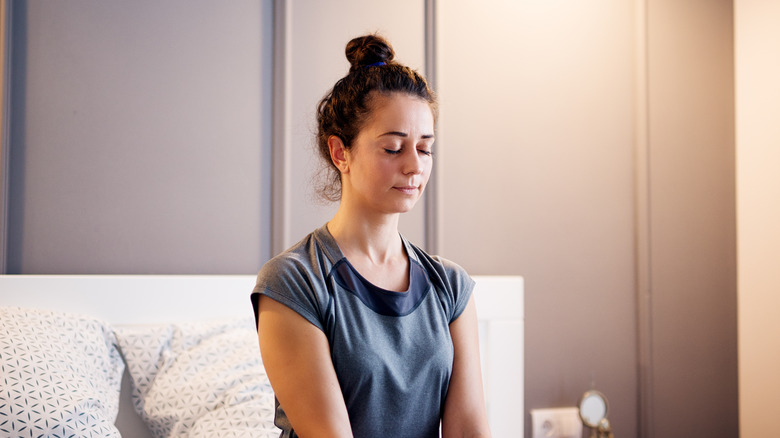 woman doing yoga in bed