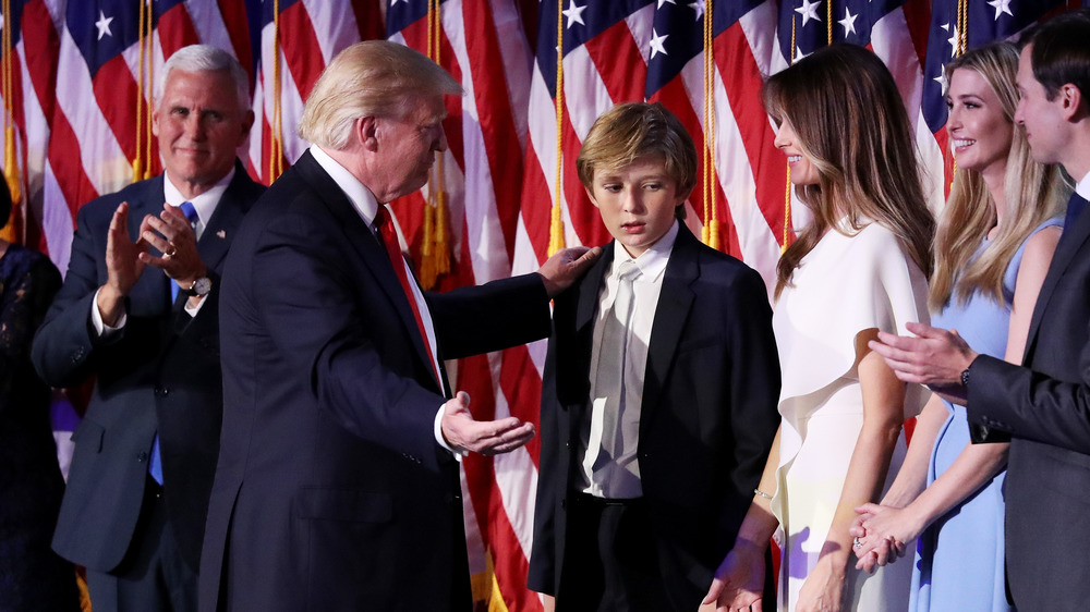 Barron Trump looking tired in suit with Donald Trump and Melania Trump