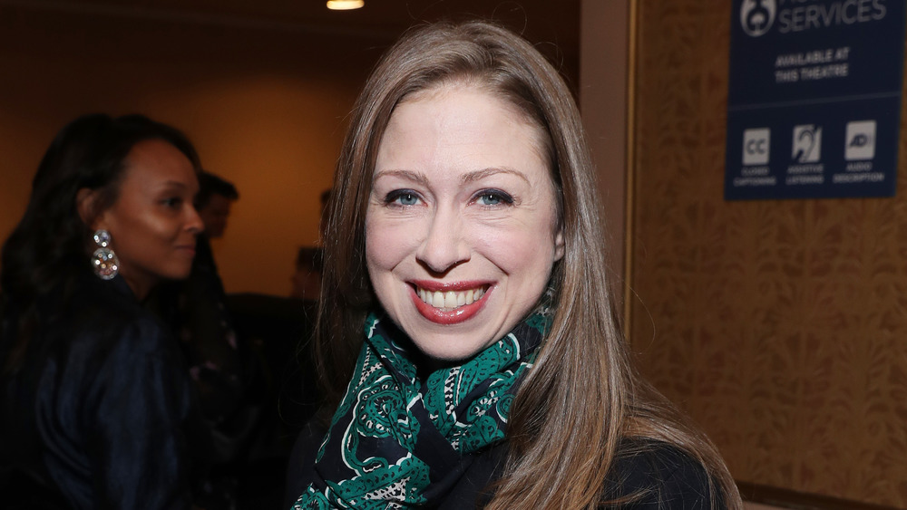 Chelsea Clinton smiling in green scarf