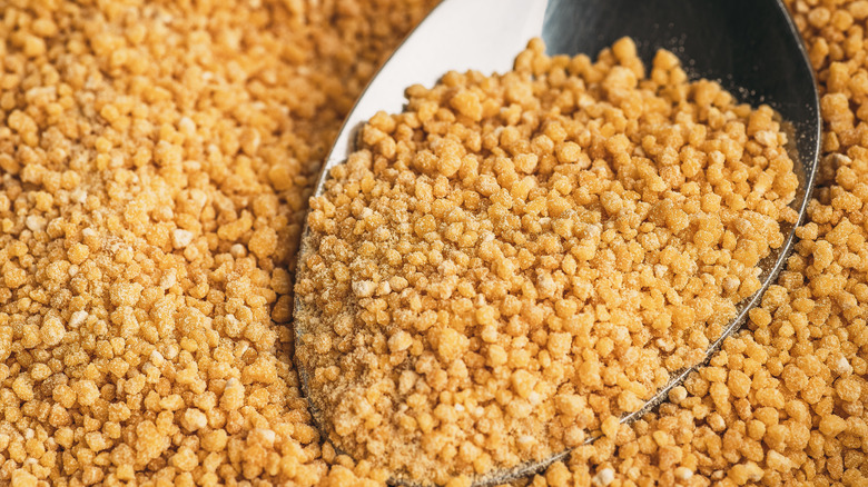 Close-up image of lecithin granules in a tablespoon 