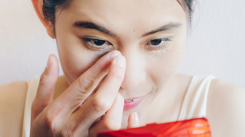 Woman applying concealer