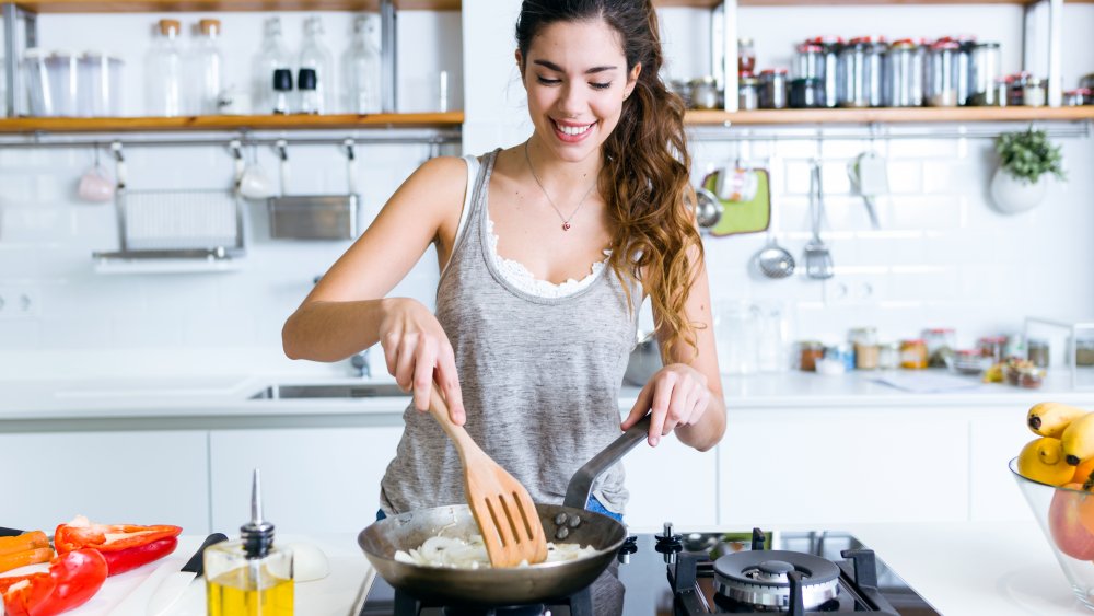 Woman cooking with oil