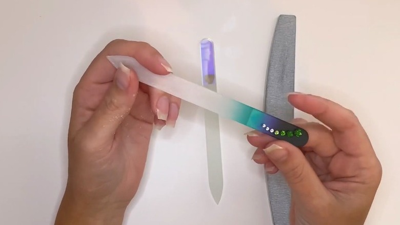 hands holding crystal nail file