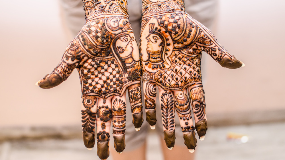Hand with traditional indian henna tattoo elements