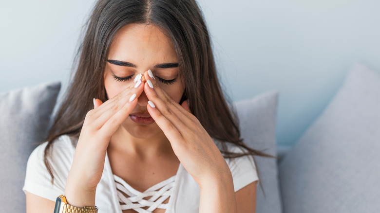 Woman with nose pain 