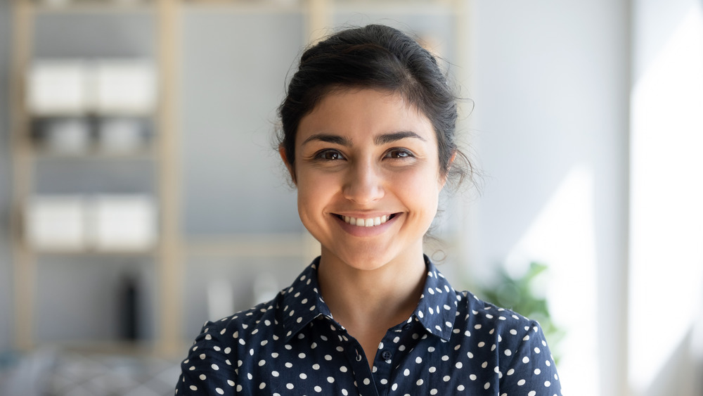 Woman smiling in polka dot shirt