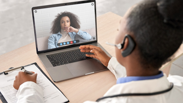 doctor video chatting with female patient