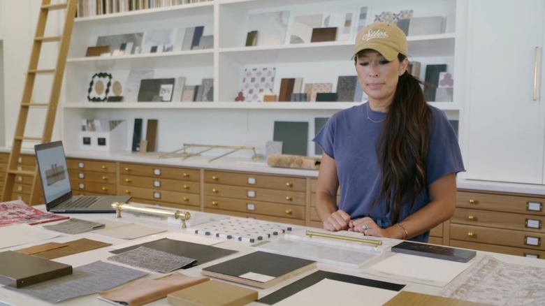 Joanna Gaines looking over color swatches and textiles