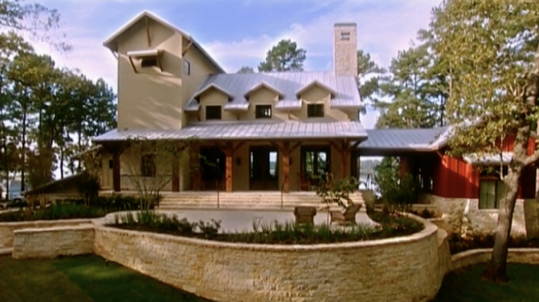 Front of house surrounded by trees